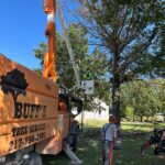 person in lift truck for tree trimming & tree pruning service